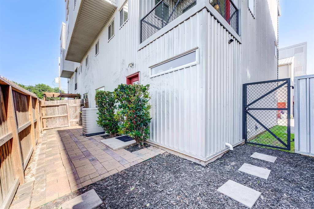 Oversized gated back patio, with low maintenance rock and pavers! With easy access side gate to guest parking space!