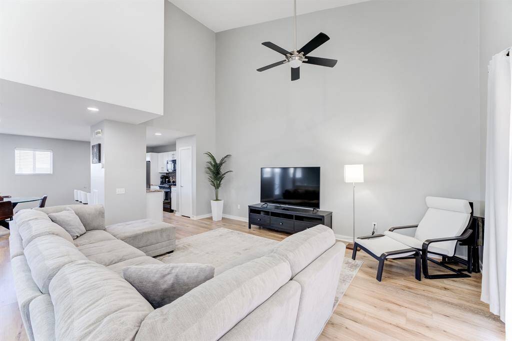 Large living room on the 2nd floor, perfect for entertaining and full of natural light! Look at those large windows and vaulted ceilings!