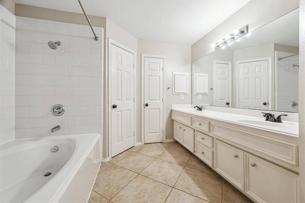 Spacious primary bathroom with large soaking tub/shower and two sinks and lots of counter space!  Rare in this community!
