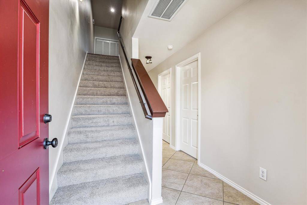 Entry, with guest bedroom and bathroom to the right and tons of extra storage under the stairs!