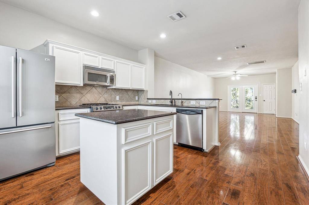 Another look at the kitchen. Here you can see the breakfast bar and all the counter space! Great spot to cook your favorite meal or entertain family and friends!