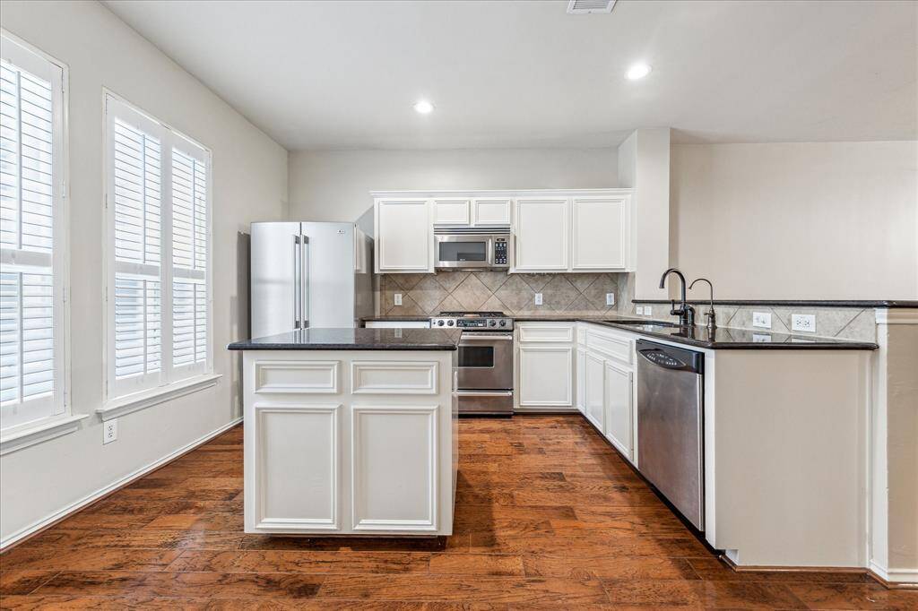 Great kitchen with lots of cabinets and counter space! Great natural light and plantation shutters throughout the house!