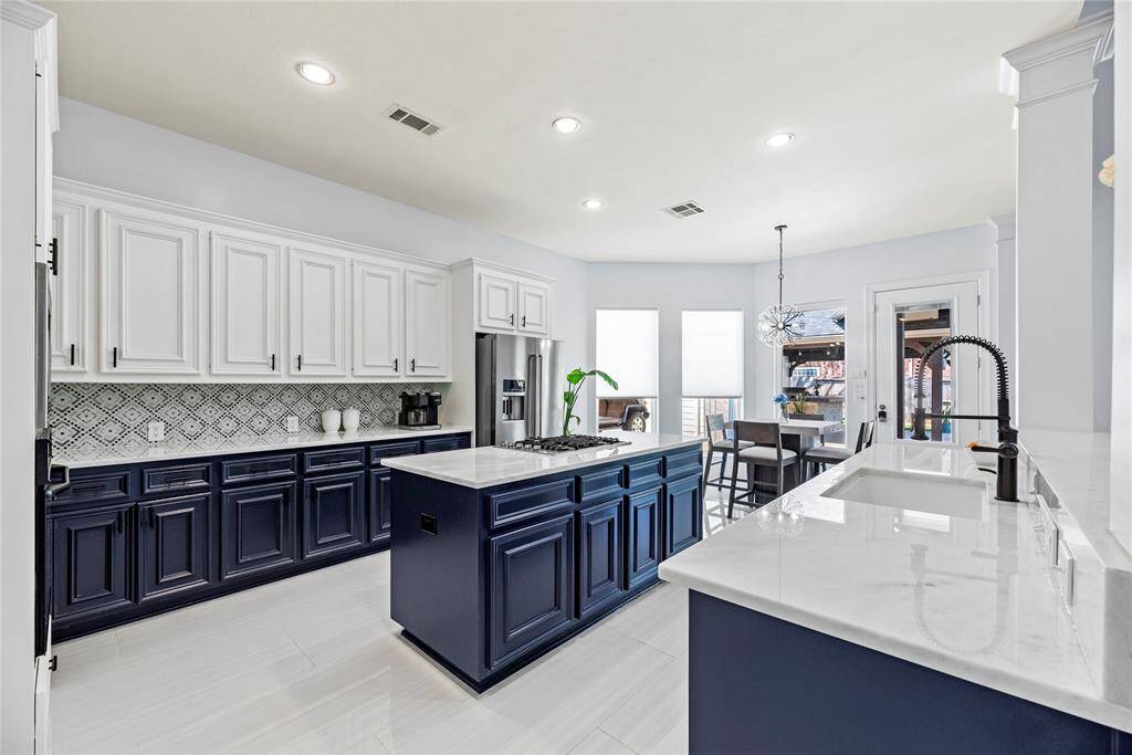 Porcelain flooring continues throughout the kitchen and breakfast area. Recent backsplash and quartz countertops installed!