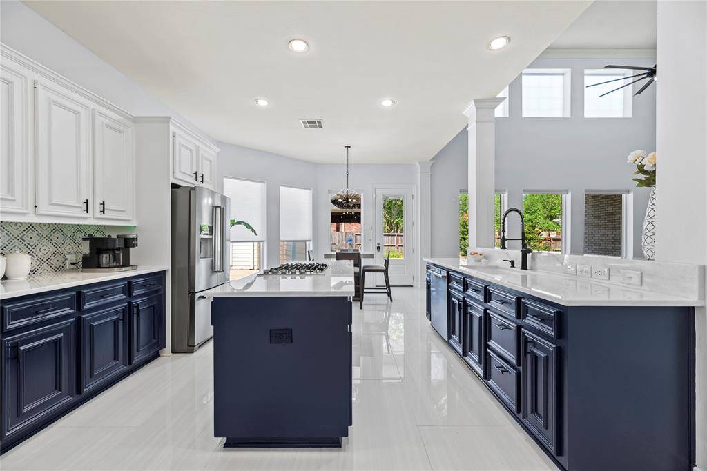 This chef's kitchen showcases double islands and built-in oven and microwave and open sightlines to the living areas.