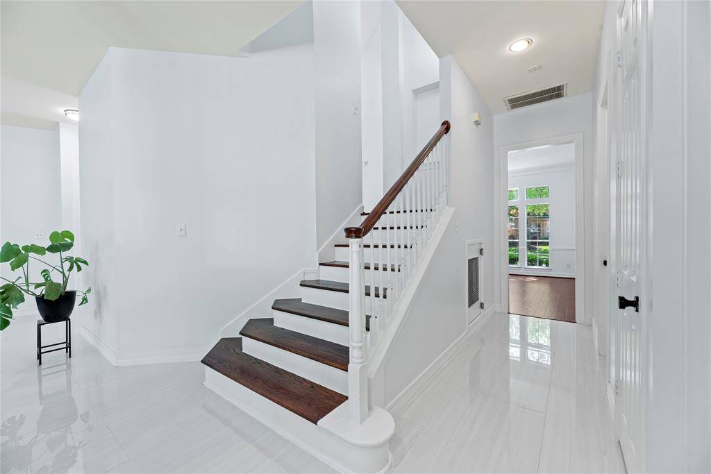 Dual staircase leads to the kitchen. Tucked nicely under the stairs is a cozy dog kennel retreat!