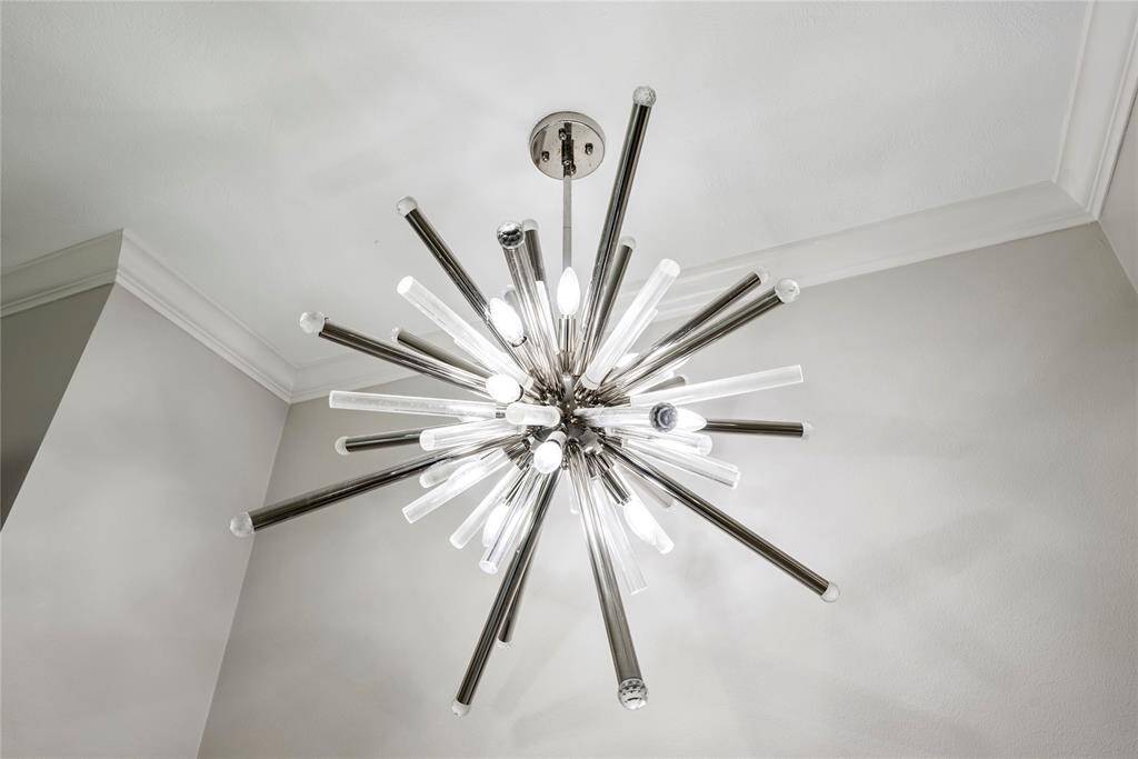 Contemporary starburst chandelier adding a stylish and artistic flair to the home’s modern aesthetic.