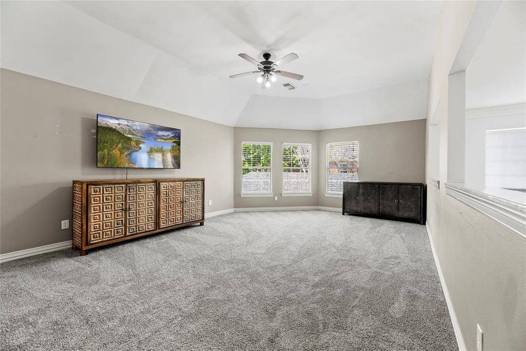 Spacious and open with plush carpeting and multiple windows.
