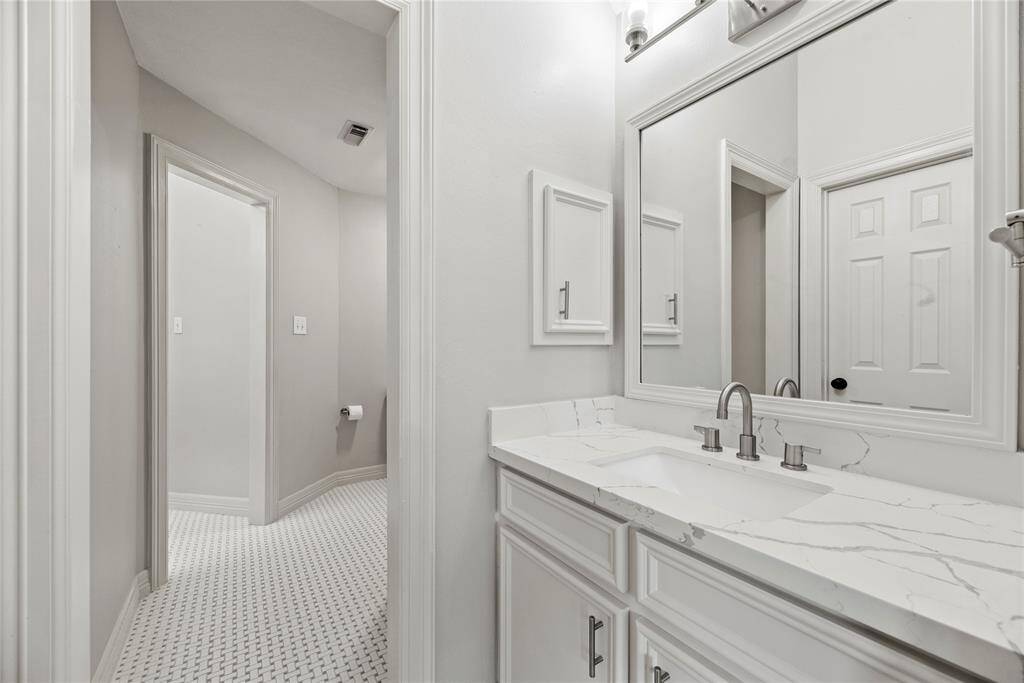 Gleaming white details complete the expansive Hollywood bath