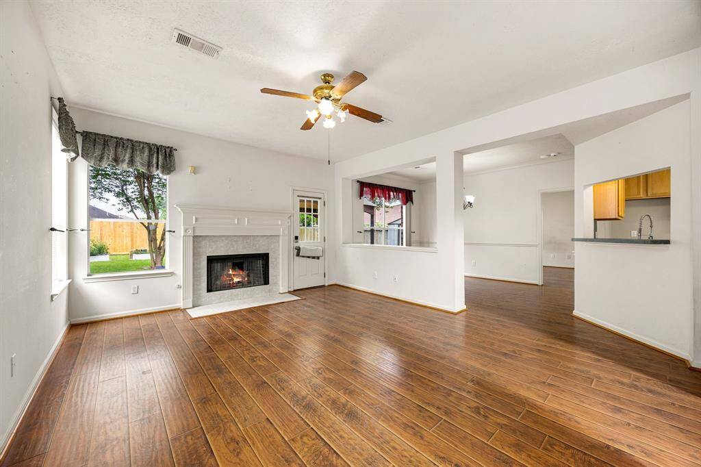 Large living room has outdoor access, a cozy fireplace and plenty of wall space for your large pieces.