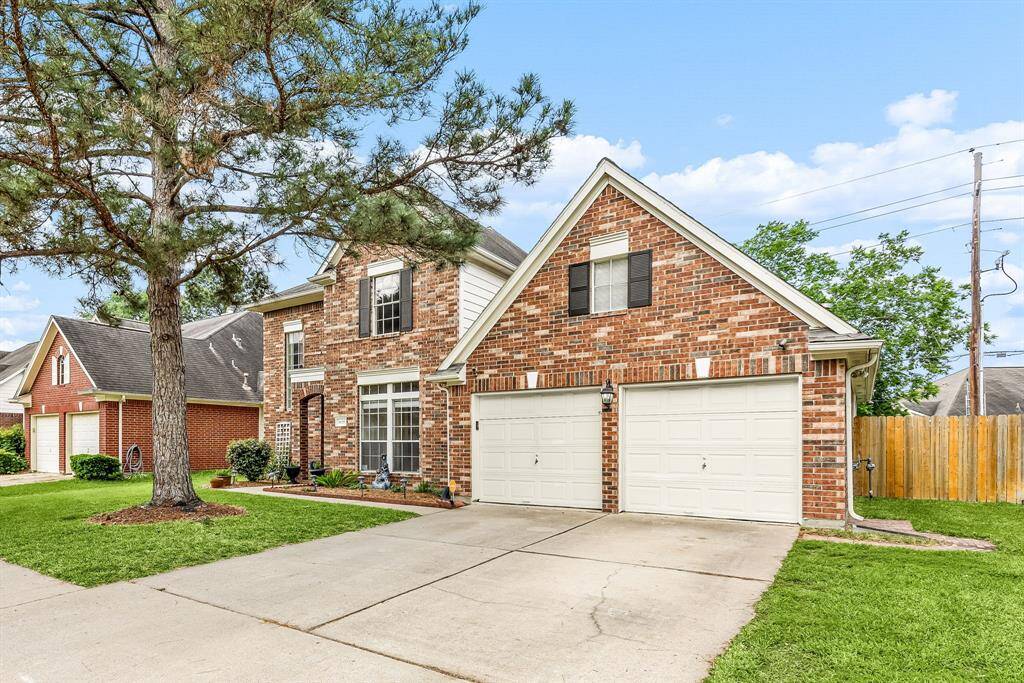 Two story home boasts of a classic brick elevation with mature trees.