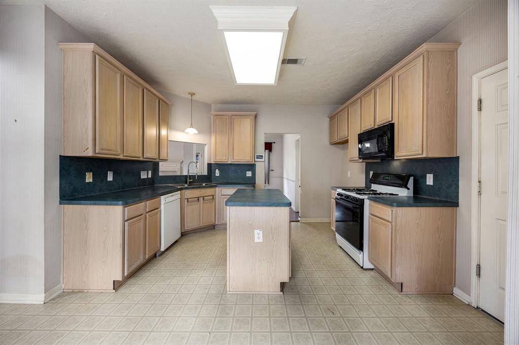 Large breakfast area window has a view of the front yard. Enjoy your meals with natural light flowing through. Peek through counter at the sink allows you to see what's happening in the living room.