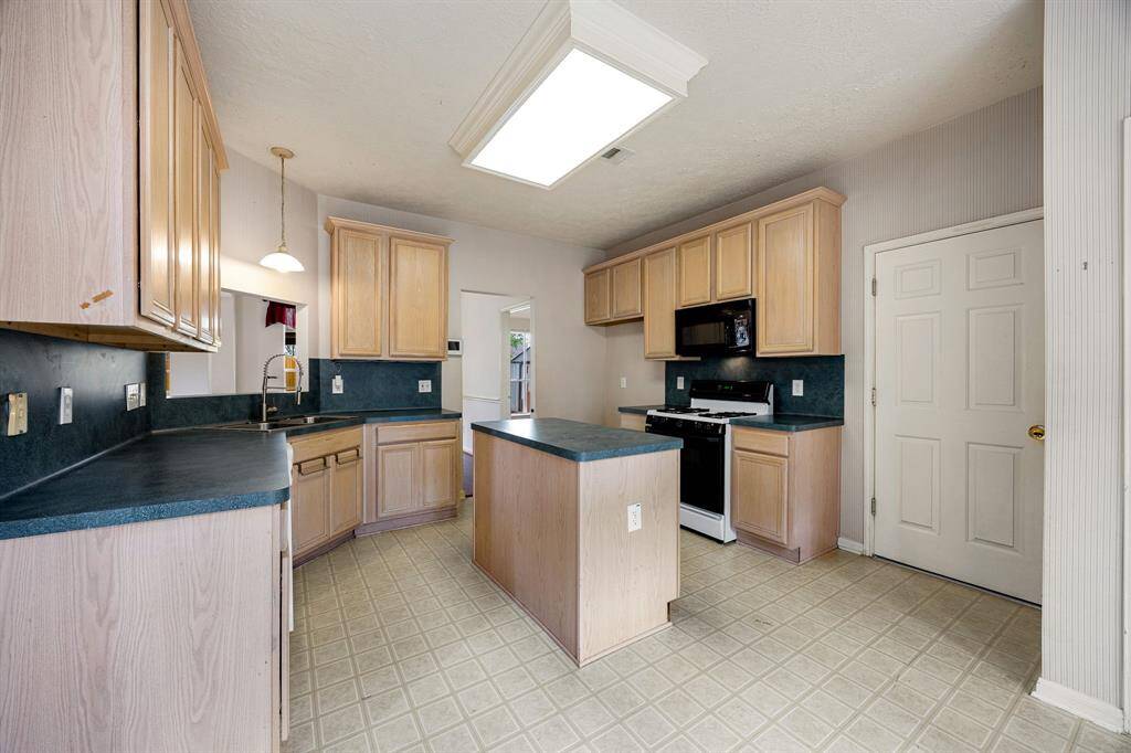 Laundry space is inside the home. Doors are in the garage and can be reattached.