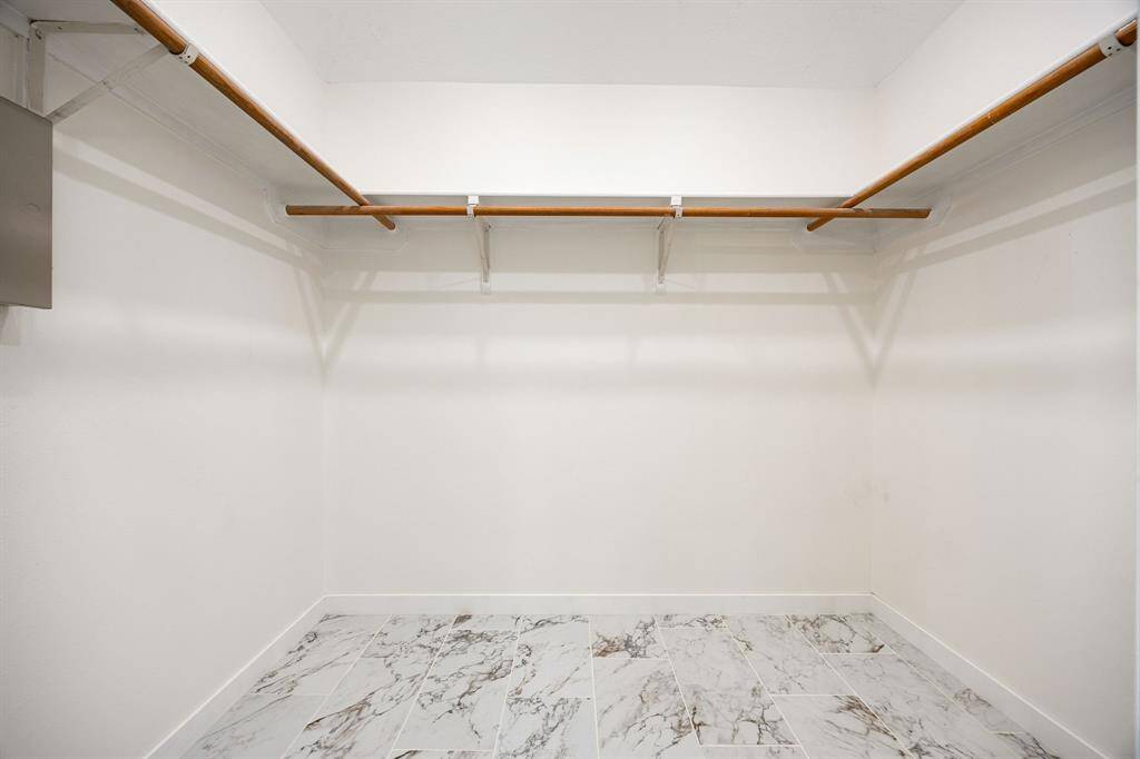 Large walk-in closet in primary bathroom.