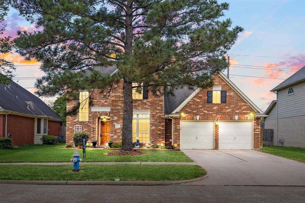 Two story home has a two car garage with ample parking space.