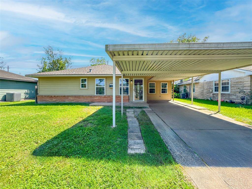 Charming curb appeal featuring a well-maintained facade, set in a friendly neighborhood. The covered carport provides convenient parking and protection from the elements.