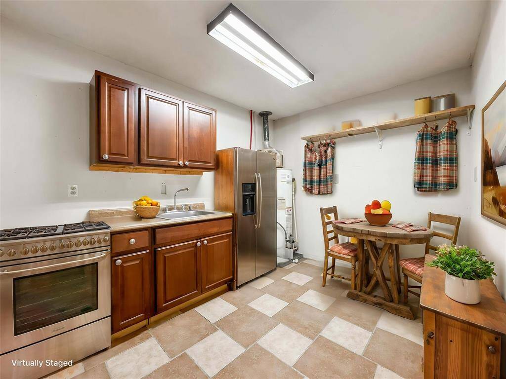 Virtually staged - Versatile second master bedroom featuring its own kitchenette—perfect for guests or a private in-law suite. A unique feature that adds flexibility to the home.