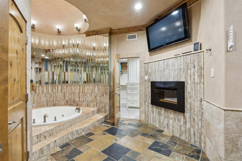 Primary bath. Open ceiling tunnel above bath to skylight. Tons of natural light.
