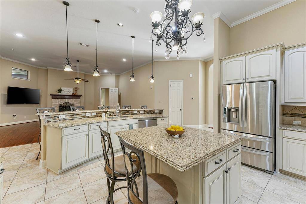 This kitchen connects seamlessly to the living area with a cozy fireplace, ideal for entertaining.