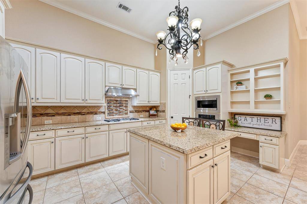 Storage galore! Chefs' kitchen with gas stovetop, tile backsplash and upgraded oversized island to accommodate 2 additional bar stools!