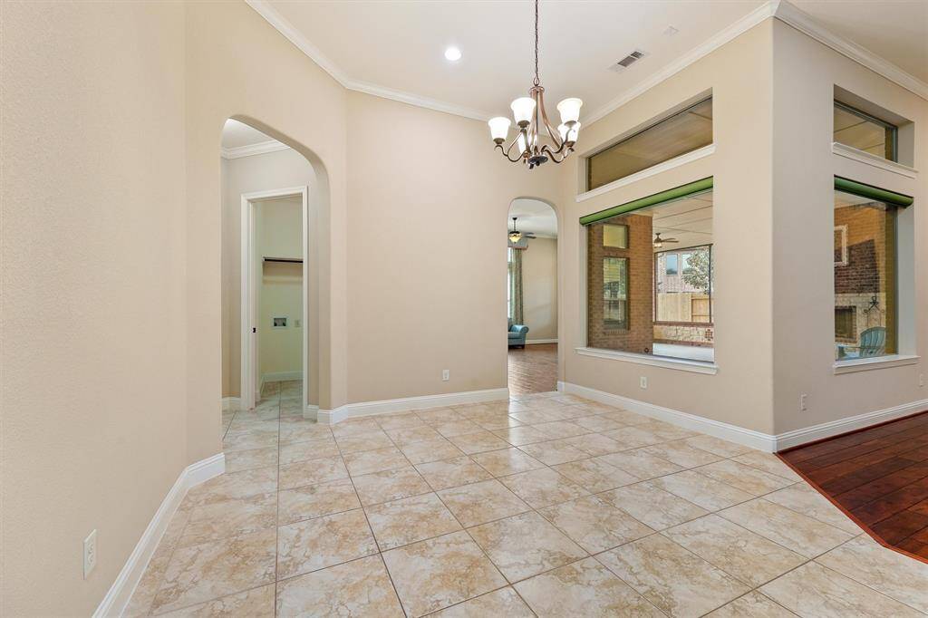 Breakfast dining area with remote controls roman shades add a touch of color and pizazz.