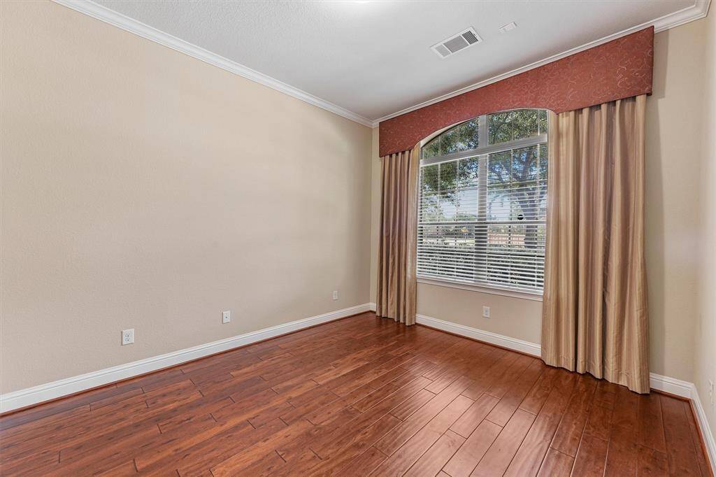 Large window with elegant drapes, allowing plenty of natural light and a view of the outdoors.