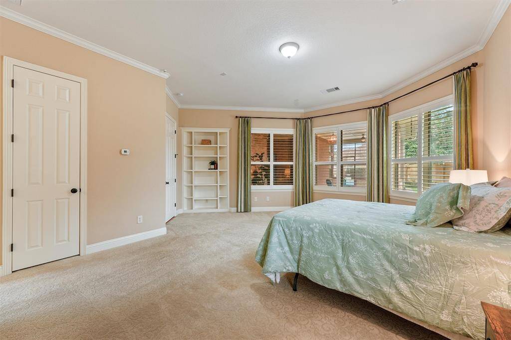 Primary also upgraded with built-in shelving for storage and elegant wood shutters as well as the 1st of 2 closets. 2nd upgraded closet is in the en-suite.