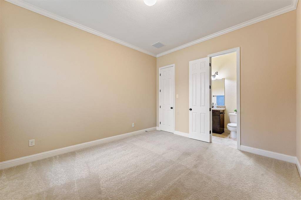 1st of 3 bedrooms with en-suites! This is a bright, spacious bedroom with neutral colors, featuring a closet and an en-suite bathroom with modern fixtures.