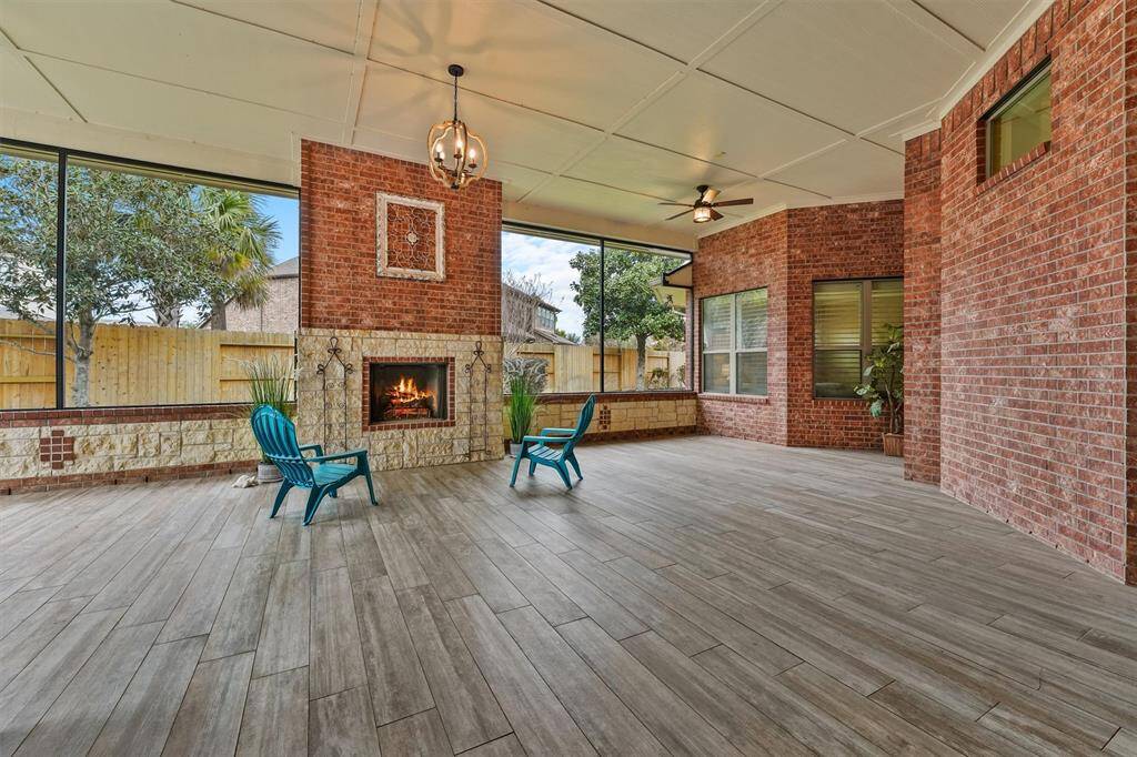 Summers coming fast! Enjoy it in style with this enormous 750+ sq ft screened in living space with brick and stone accents, featuring a massive fireplace, modern chandelier and 3 ceiling fans. Gas plumbed for an outdoor kitchen/grill! Polaris pool cleaner and additional pool equipment to convey with home. Replace the screens with windows and condition the space to add 750 sq ft to your indoor living space/value!