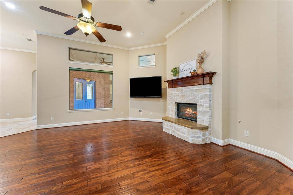 This spacious living room features elegant real hardwood floors, a cozy stone gas fireplace focal point with a stunning wood mantle. It's the center of the home open to the kitchen which is, of course, the heart of the home.