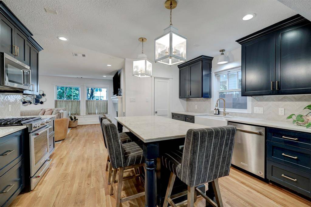 Kitchen features designer finishes and a large butlers pantry with Quartizite counters and seating that allows views of front and backyards!