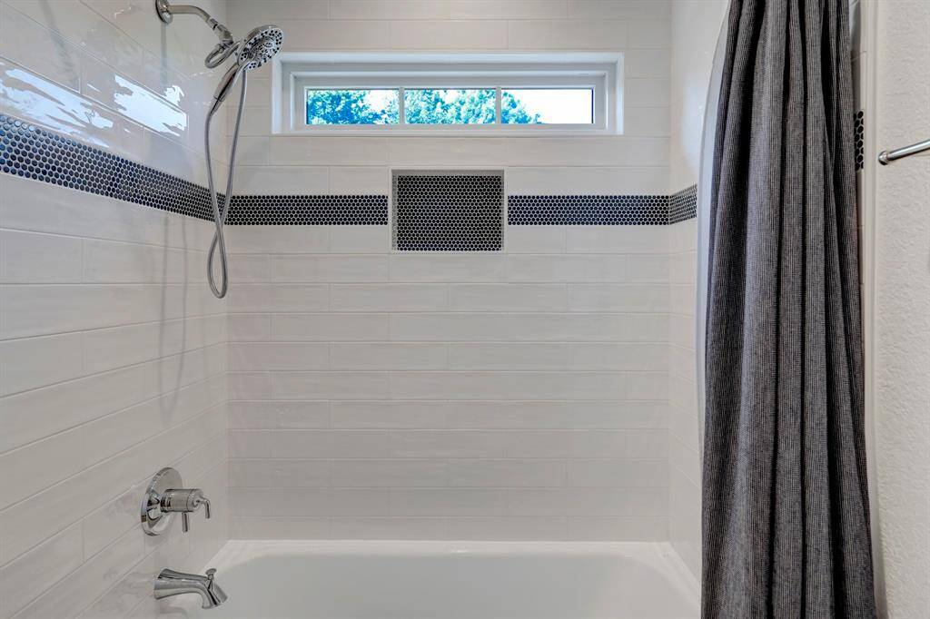 This penny blue tile was a special design for University of Houston and designer snagged it for this bathroom! It can't be found anywhere else in this hue!