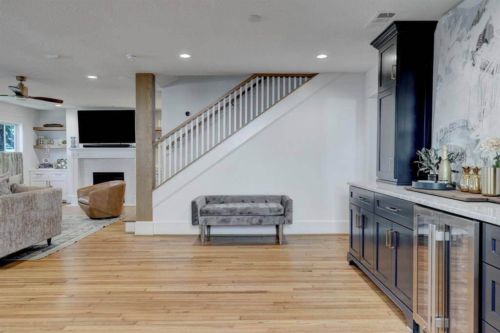 Entryway and bar area features mud room type cabinetry and wine fridge.