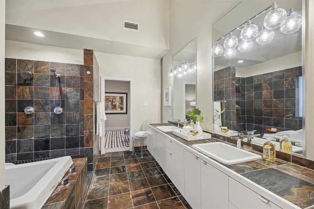 Open shower/wet room with soaking tub with tile deck and surround. Hansgrohe shower head, hand shower and faucets.