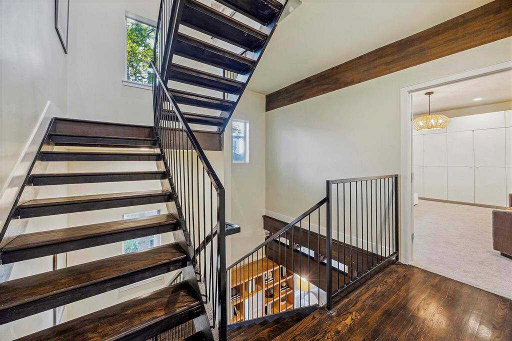 Custom metal and wood stairs leading to the 4th level roof deck Entrance to third floor primary bedroom shown here.