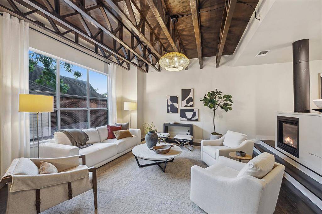 [Living Room 17 x 18] Second floor living area with wall of windows. Has stained trusses, gas log fireplace, oak hardwood floor.