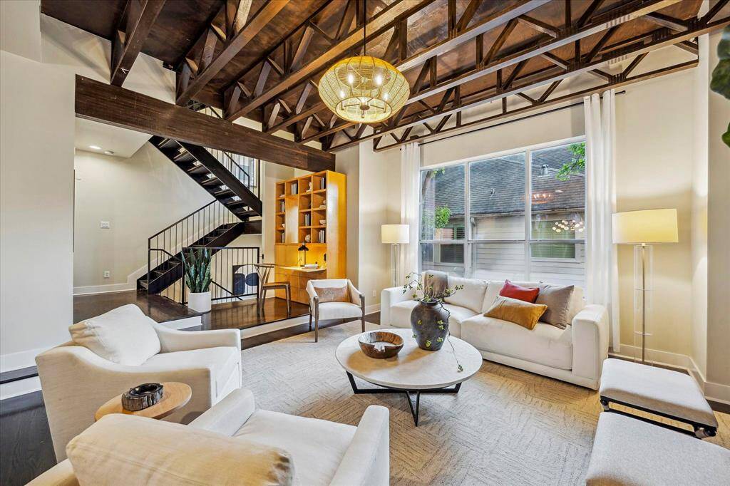 Open-concept living with soaring ceilings and seamless flow between living, dining, and kitchen.