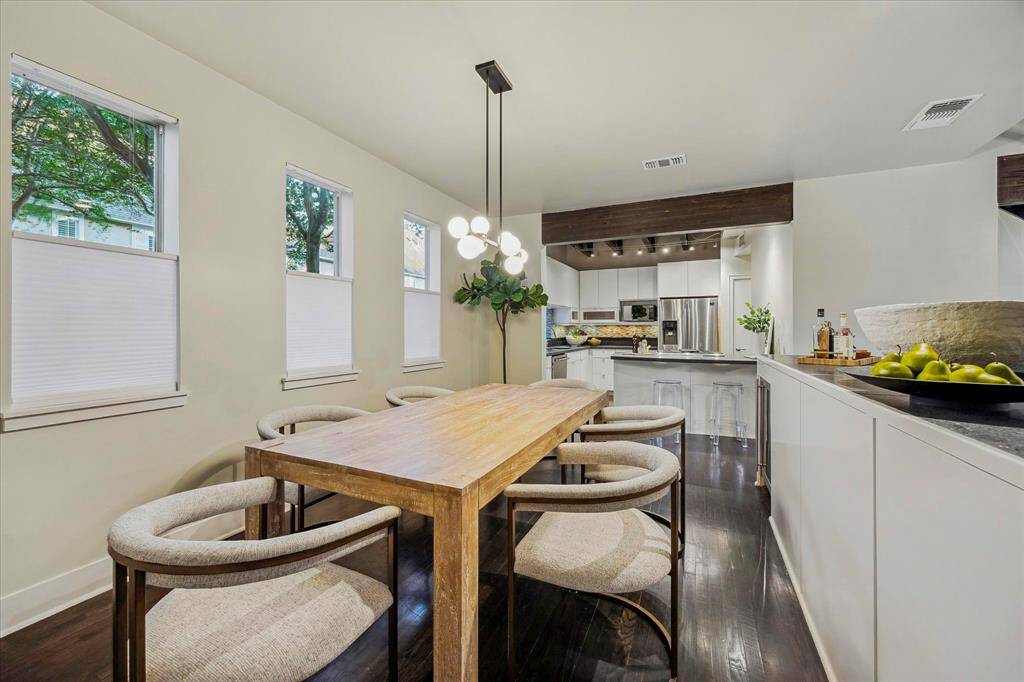 Dining room has direct access to serving bar and kitchen. Serving bar with honed granite and beverage fridge.