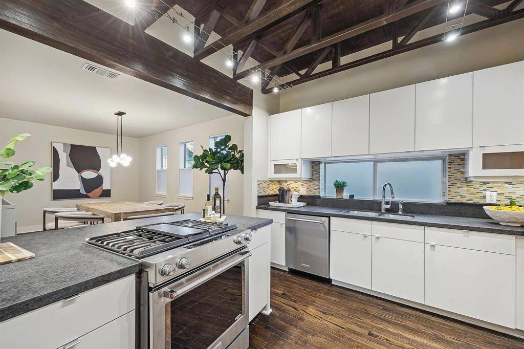[Kitchen 12 x 11] Modern kitchen with hardwood floors, honed granite counters, abundant storage, stainless appliances including gas range.