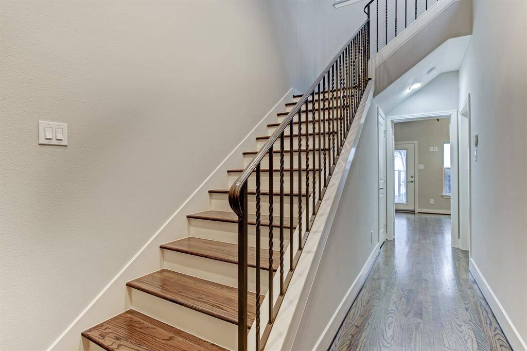 Entry Foyer w dramatic high ceilings & wrought iron staircase