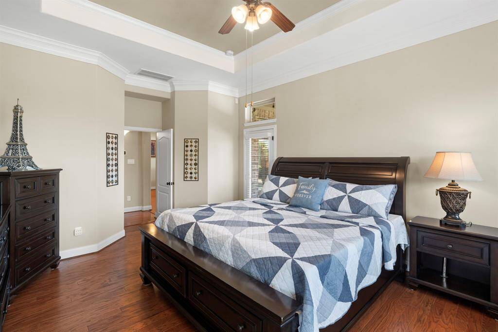 The first-floor primary suite is a true retreat, featuring private access to the patio and pool area.