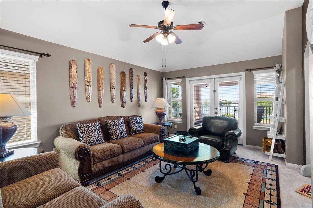 Upstairs, you'll find a spacious game room with French doors leading to a covered second-floor patio that overlooks the pool and serene lake beyond.
