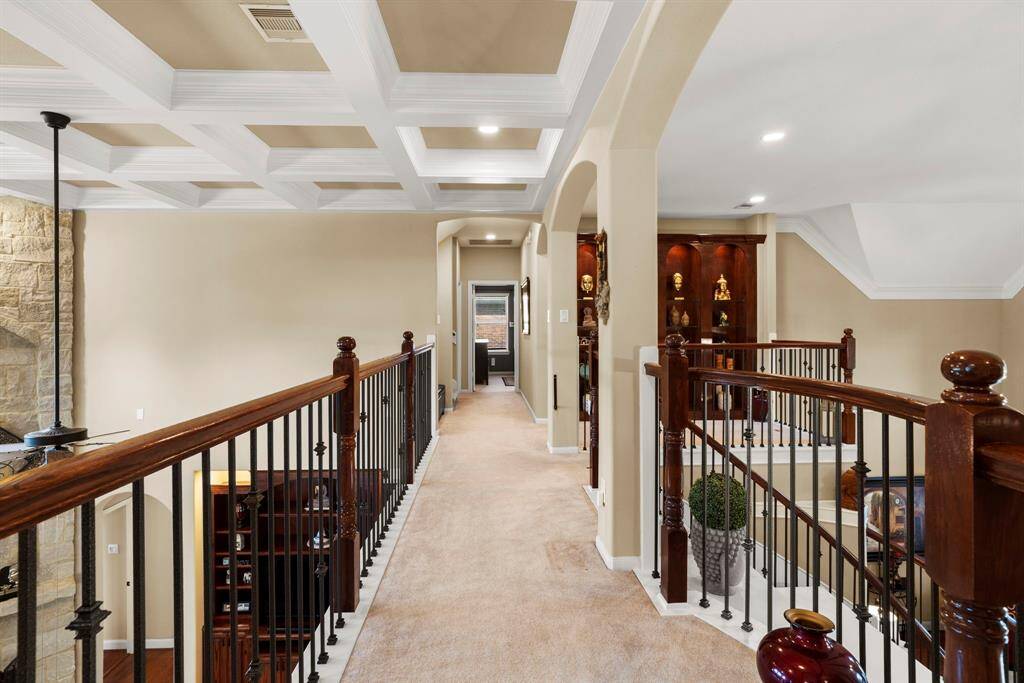 Open hallways maintain a light and airy ambiance, enhancing the spacious feel of the home.