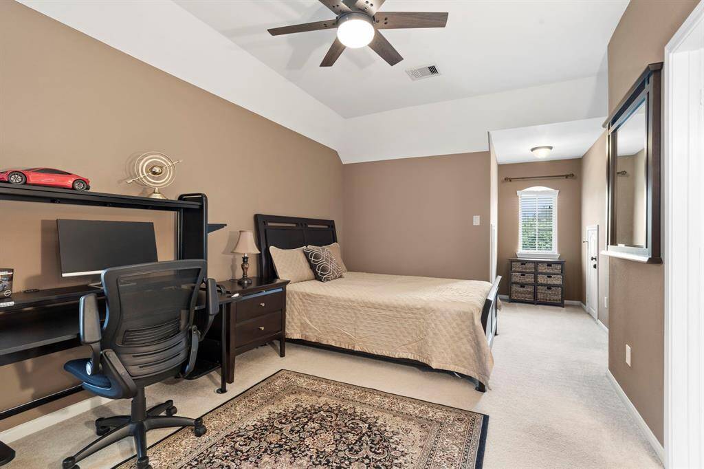 This bedroom also features walk-in attic storage, offering added convenience and ample space for organization and seasonal storage.