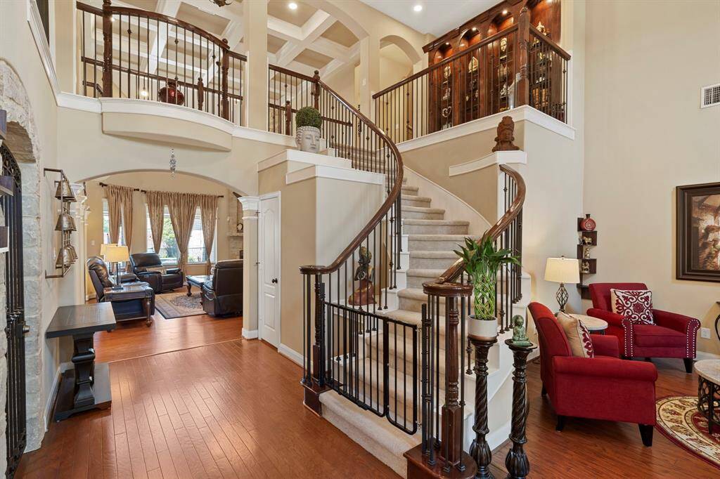 As you enter, you’re greeted by a grand formal entrance with soaring 2-story ceilings and a sweeping curved staircase, setting the tone for the elegance throughout the home.