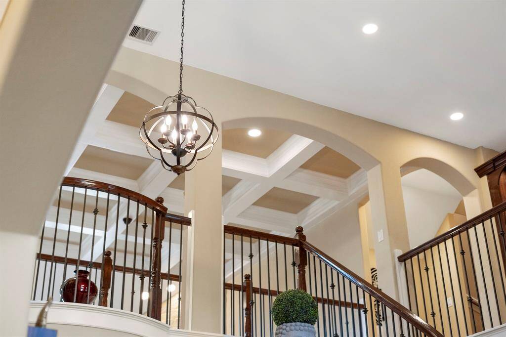 From the coffered ceiling to the open arched walls and contemporary light fixtures, every detail has been meticulously designed in this exquisite home.