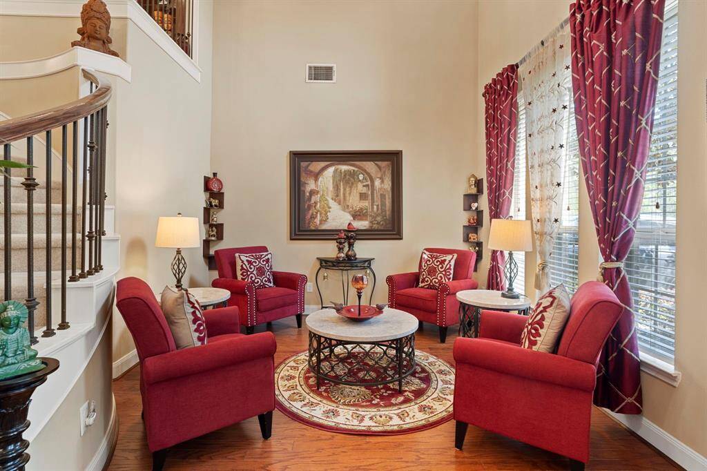 Large windows bathe the formal living room with natural light.