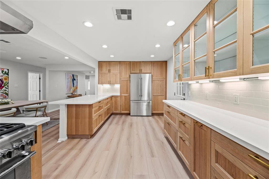 Chef’s kitchen with ample cabinets is perfect for entertaining.