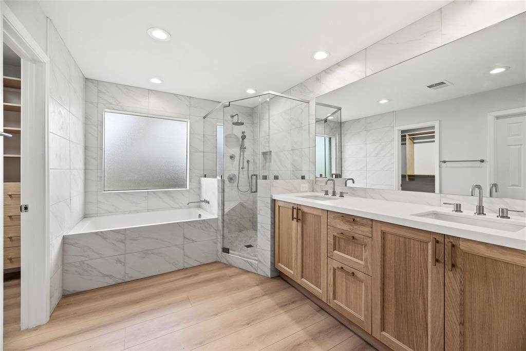 Spa like primary bath with soaking tub, separate shower and double vanity.