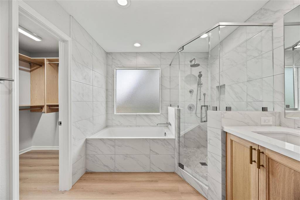 Spa like primary bath with soaking tub, separate shower and double vanity.