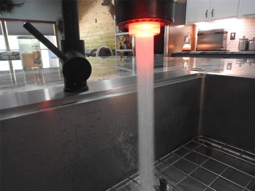 Sink is situated on the Kitchen Island. Be Careful; the water is HOT-Red Light, WARM-Green Light, COLD-Blue Light.